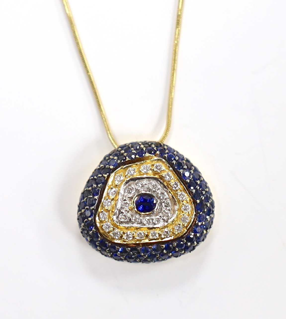 A modern 750 yellow metal, sapphire and diamond cluster set pendant necklace, overall 44cm, gross weight 9.3 grams.